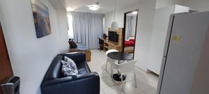 a living room with a couch and a chair at Flat Sorriso - Beach Class Conventions in Recife