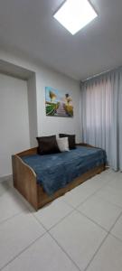a bedroom with a large bed with a blue blanket at Flat Sorriso - Beach Class Conventions in Recife +56 photos
