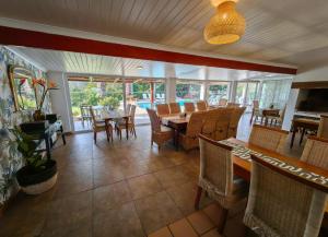 a dining room with a table and chairs at Oyster Bay Lodge in Oyster Bay