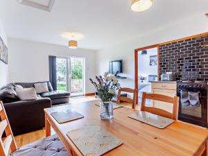 a living room with a table and a kitchen at 2 bed property in Bath 37147 in Chew Magna