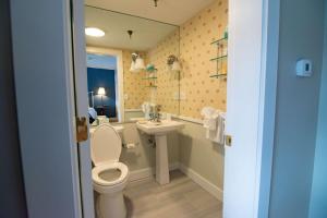 a bathroom with a toilet and a sink at The Beach House Inn in Kennebunk