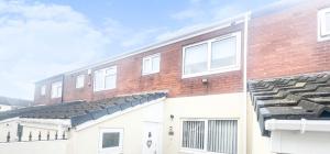 a brick building with white doors and windows at Stylish 3 bed house with free parking in Belle Isle