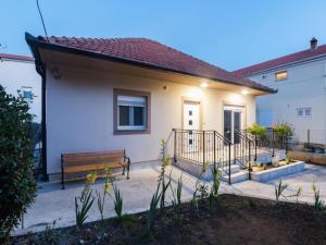 a house with a bench in front of it at Mihael Holiday House in Zadar