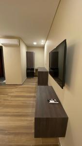a living room with a couch and a flat screen tv at Adobe Suites in Salta +28 photos