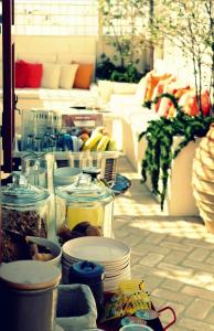a bunch of food in jars on a patio at La Maison Kalogera in Mikonos