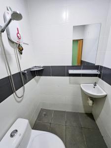 a bathroom with a toilet and a sink at The 60 in George Town