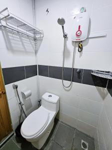 a bathroom with a toilet and a shower at The 60 in George Town