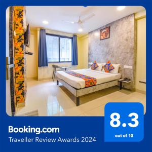 a hotel room with a bed in a room at FabHotel Gargi Inn in Pune