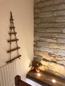 a fireplace with a christmas tree on a stone wall at Ca' Cuore in Monferrato in Serralunga di Crea