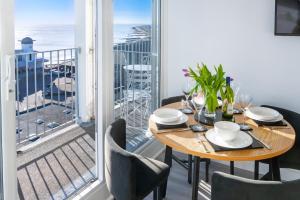 a dining room with a table and a view of the ocean at 19 Undercliffe in Felixstowe