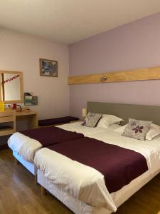 Postel nebo postele na pokoji v ubytování Hôtel Mélodie