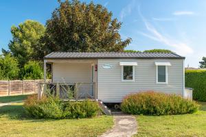 a tiny house is parked in a yard at Azureva Fouras in Fouras