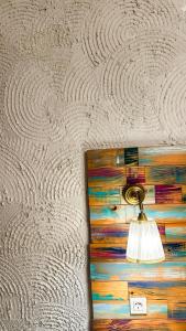 a lamp on a wall with a wooden drawer at Boho House in Pakoštane