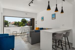 a kitchen and living room with a table and chairs at Heylon Court 110 in Cape Town
