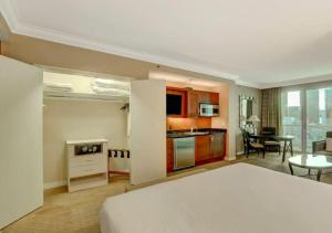 a bedroom with a bed and a kitchen with a table at Luxury Studio With Balcony At Las Vegas in Las Vegas