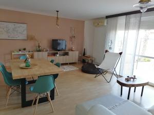 a living room with a wooden table and chairs at El Vergel del Piedra in Munébrega