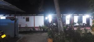 una casa con luces al costado de ella por la noche en Nilaveli Beach Rooms, en Nilaveli