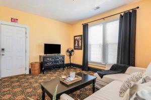 a living room with a couch and a table at Spacious upstairs 1bed- Walking distance to Beach outlet mall in Michigan City