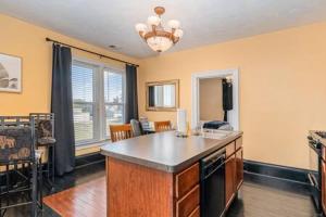 a kitchen with an island in the middle of a room at Spacious upstairs 1bed- Walking distance to Beach outlet mall in Michigan City