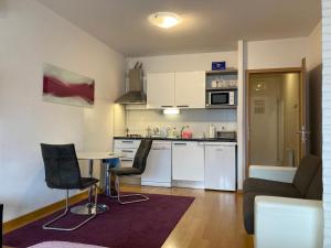 a kitchen and living room with a table and chairs at Apartment Green Gold in Zagreb