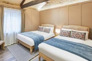 a bedroom with two beds and a window at Host & Stay - Hecklers Cottage, Barnard Castle in Barnard Castle