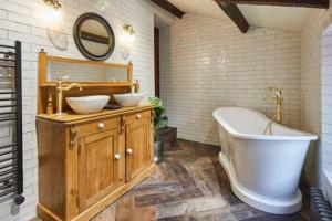 a bathroom with two sinks and a bath tub at Host & Stay - Hecklers Cottage, Barnard Castle in Barnard Castle +10 photos