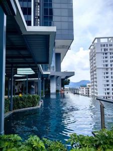 a swimming pool in the middle of a building at LS Tropicana 218*Sea View*1BR*Georgetown*King Bed in George Town