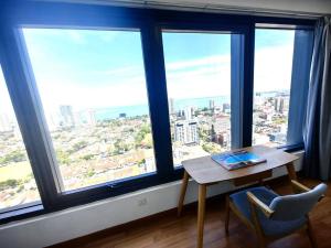 a table in a room with a large window at LS Tropicana 218*Sea View*1BR*Georgetown*King Bed in George Town