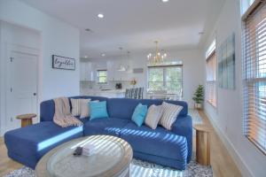 a living room with a blue couch and a kitchen at Inlet Escape in Myrtle Beach