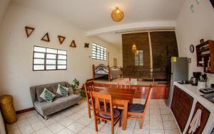 a kitchen and living room with a table and a couch at Bleibe- Quédate! in Bacalar