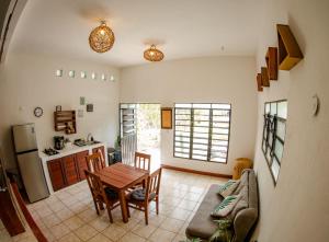 a living room with a table and a kitchen at Bleibe- Quédate! in Bacalar
