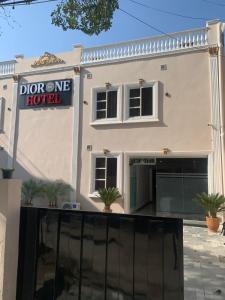 a house with a sign that readslor one hotel at Dior One Hotel in Lahore