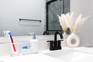 a bathroom sink with toothbrushes and a mirror at Corporate Housing by MGM in Whitestown