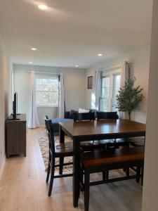 a dining room with a table and chairs and a couch at Silver Spring Serene 2BR 2BA, Nature And Access in Silver Spring