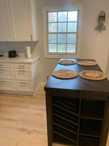 three pizzas sitting on top of a counter in a kitchen at Tranquil Trio 6 BR, 4 BA, 3 Units, Deer Haven in Silver Spring