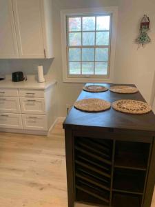 three pizzas sitting on top of a counter in a kitchen at Serene Lush 2BR Gem, on 1 acre Silver Spring in Silver Spring