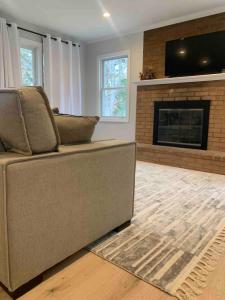 a living room with a couch and a fireplace at Serene Lush 2BR Gem, on 1 acre Silver Spring in Silver Spring