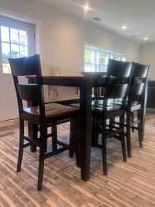 a black dining room table with black chairs at Silver Spring Serene 2BR2BA, Nature And Access in Silver Spring