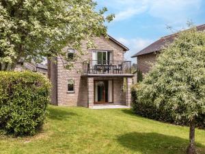 a brick house with a balcony in the yard at 2 Bed in St. Mellion 87708 in St Mellion