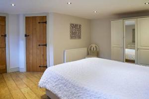 a bedroom with a large white bed and a mirror at Host & Stay - Derwent in Consett +9 photos