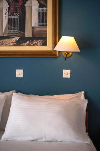 A bed or beds in a room at Kouros Hotel