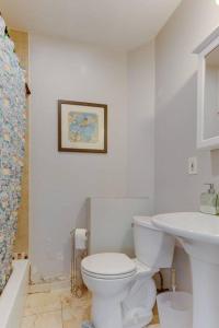 a white bathroom with a toilet and a sink at NEW! Boston Condo Near MBTA, 3Mi to Fenway ! (U3) in Boston