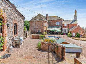 a brick house with a swimming pool in a yard at 3 Bed in Exeter KENCI in Clyst Saint Mary