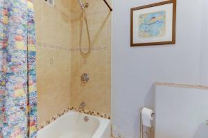 a bathroom with a shower and a bath tub at NEW! Boston Condo Near MBTA, 3Mi to Fenway ! (U3) in Boston +15 photos