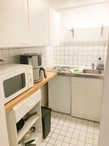 a kitchen with a microwave and a sink at Countryapartment Eifel in Kall