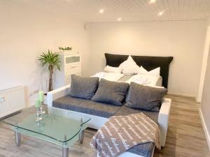 a living room with a couch and a bed at Countryapartment Eifel in Kall