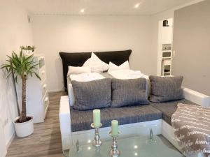 a living room with a bed and a glass table at Countryapartment Eifel in Kall