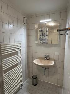 a white bathroom with a sink and a shower at Haus Allgäu Ruh in Görisried