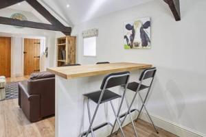 a kitchen with two stools at a counter in a room at Host & Stay - Cote in Consett +11 photos