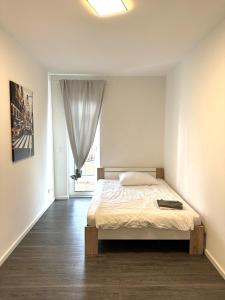 Habitación blanca con cama y ventana en Luxuriöse Loft Wohnung in Paderborn en Paderborn